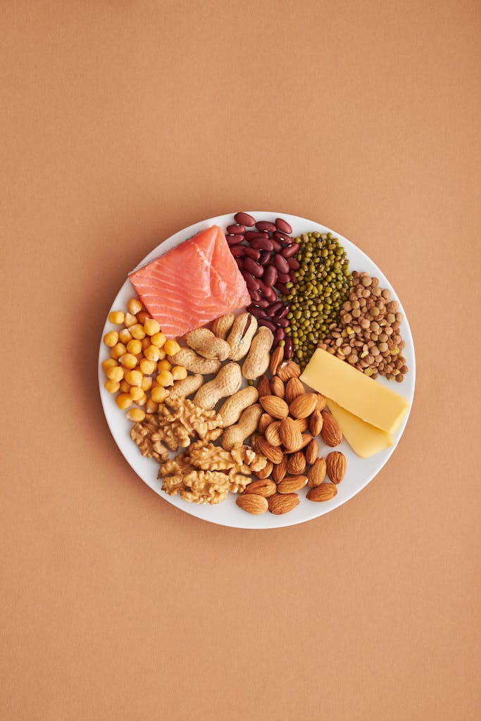 Colorful plate of healthy proteins and legumes including nuts, beans, salmon and eggs for weight loss diet